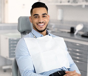 Patient smiling while sitting in treatment chair