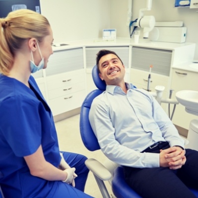 Dental patient smiling at dental team member