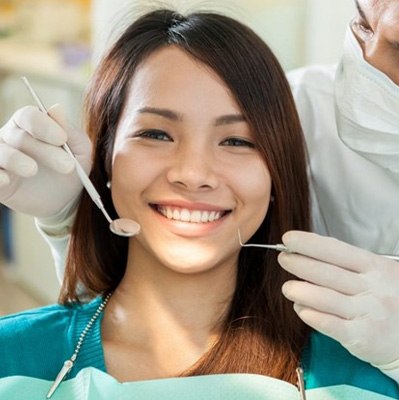 a patient smiling while visiting her cosmetic dentist 