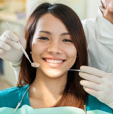 a patient smiling while visiting her cosmetic dentist