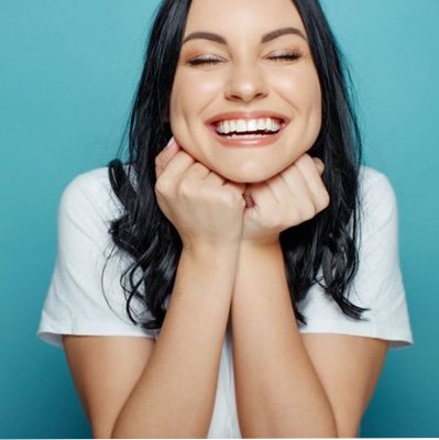 a patient smiling after receiving cosmetic dentistry