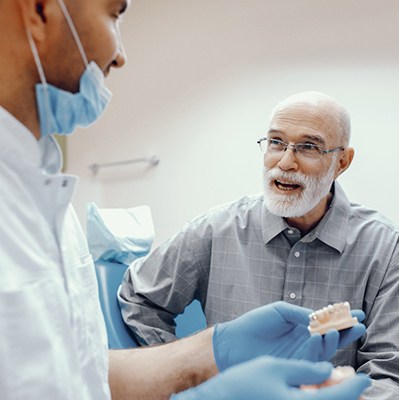 a patient at the dentist to receive dentures