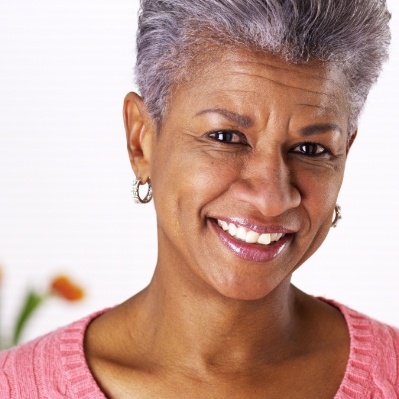 Woman smiling after tooth extractions