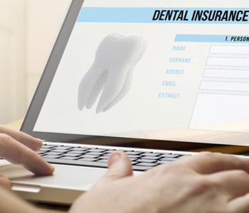 a person filling out a dental insurance form