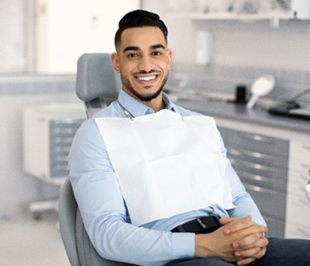 a dental patient smiling while seated for treatment