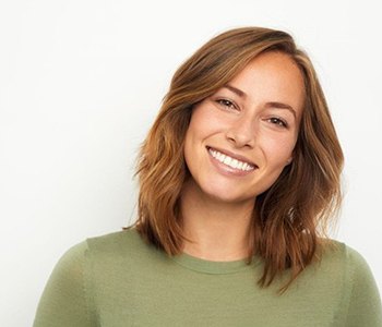 a patient with dental implants smiling 