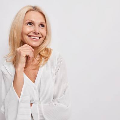 Portrait of beautiful, smiling older woman in white blouse