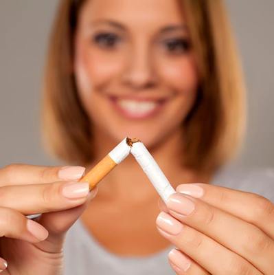 Woman breaking cigarette in half