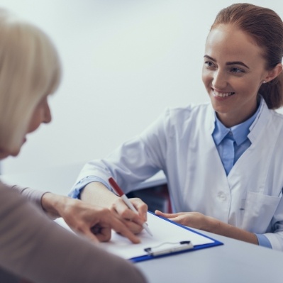 Dental team member helping patient understand how dental insurance works