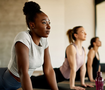Group of woman stretching in yoga class