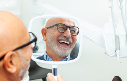 a patient with dental implants smiling