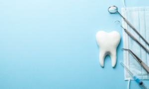 assorted dental tools against a blue background