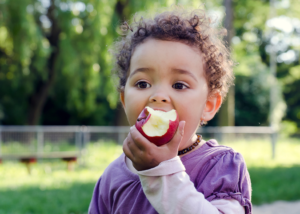 a patient snacking on a piece of fruit 