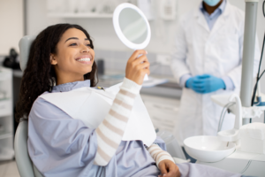 a patient smiling and chatting with their dentist