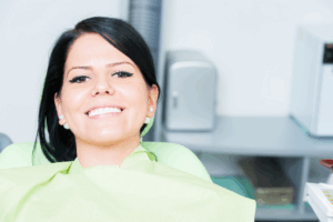 a patient relaxing and smiling at the dentist’s office