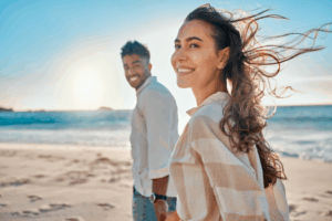 a young couple smiling while enjoying the summer weather