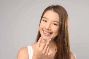 a close-up of a patient holding her Invisalign aligner